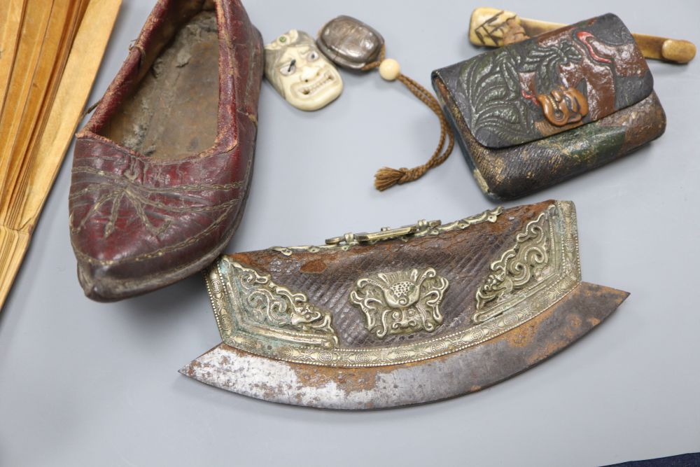 A Japanese ruyi sceptre okimono, together with a stamped leather tobacco pouch, a tinder strike, a leather Chinese childs shoe, a fan,